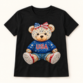 USA Rhinestone Bear Shirt | Patriotic Teddy Bear T-Shirt, Toddler Youth Adult — styled product mockup on cream background