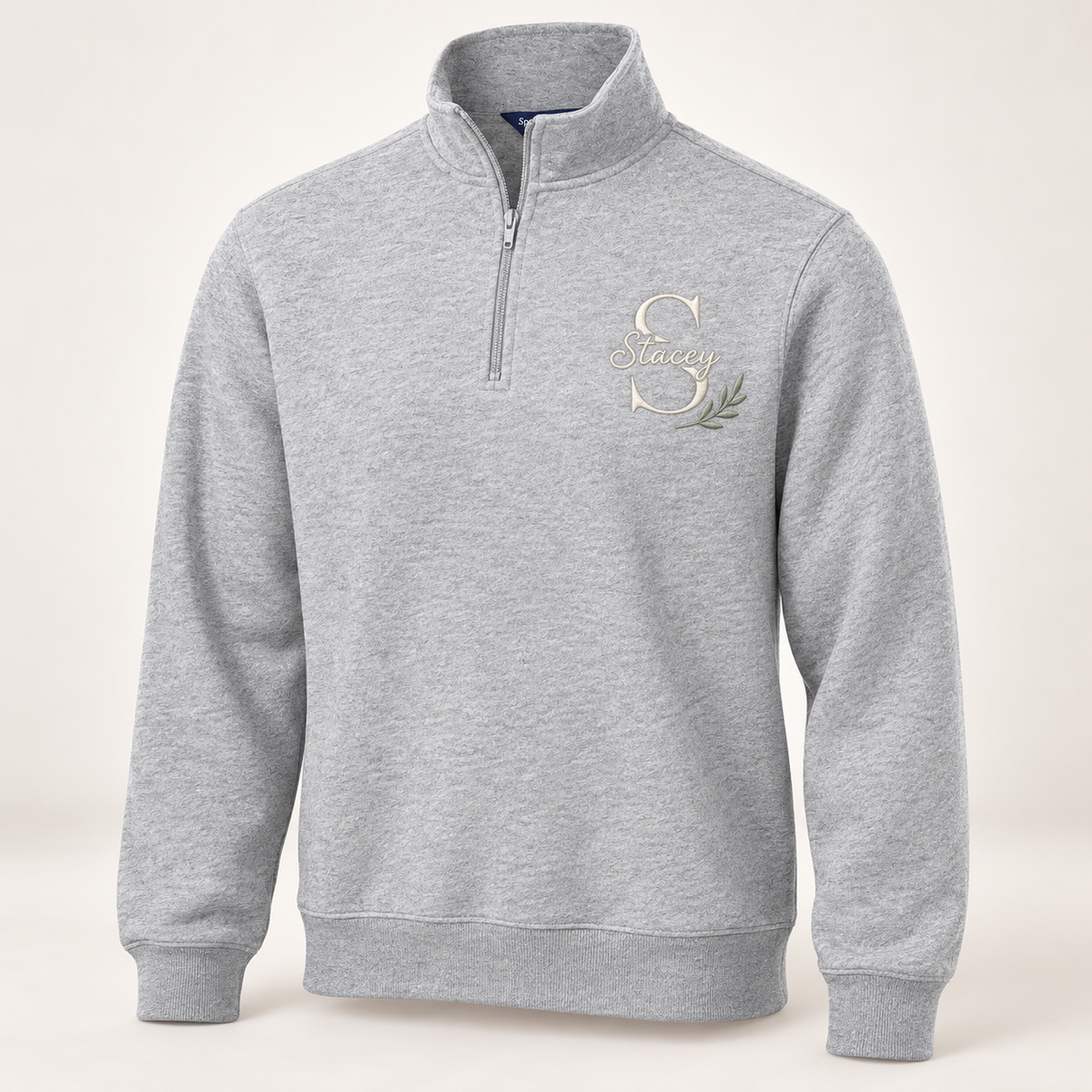 Sport-Tek ST253 in Athletic Heather — illustrative embroidered S and Stacey monogram with botanical accent